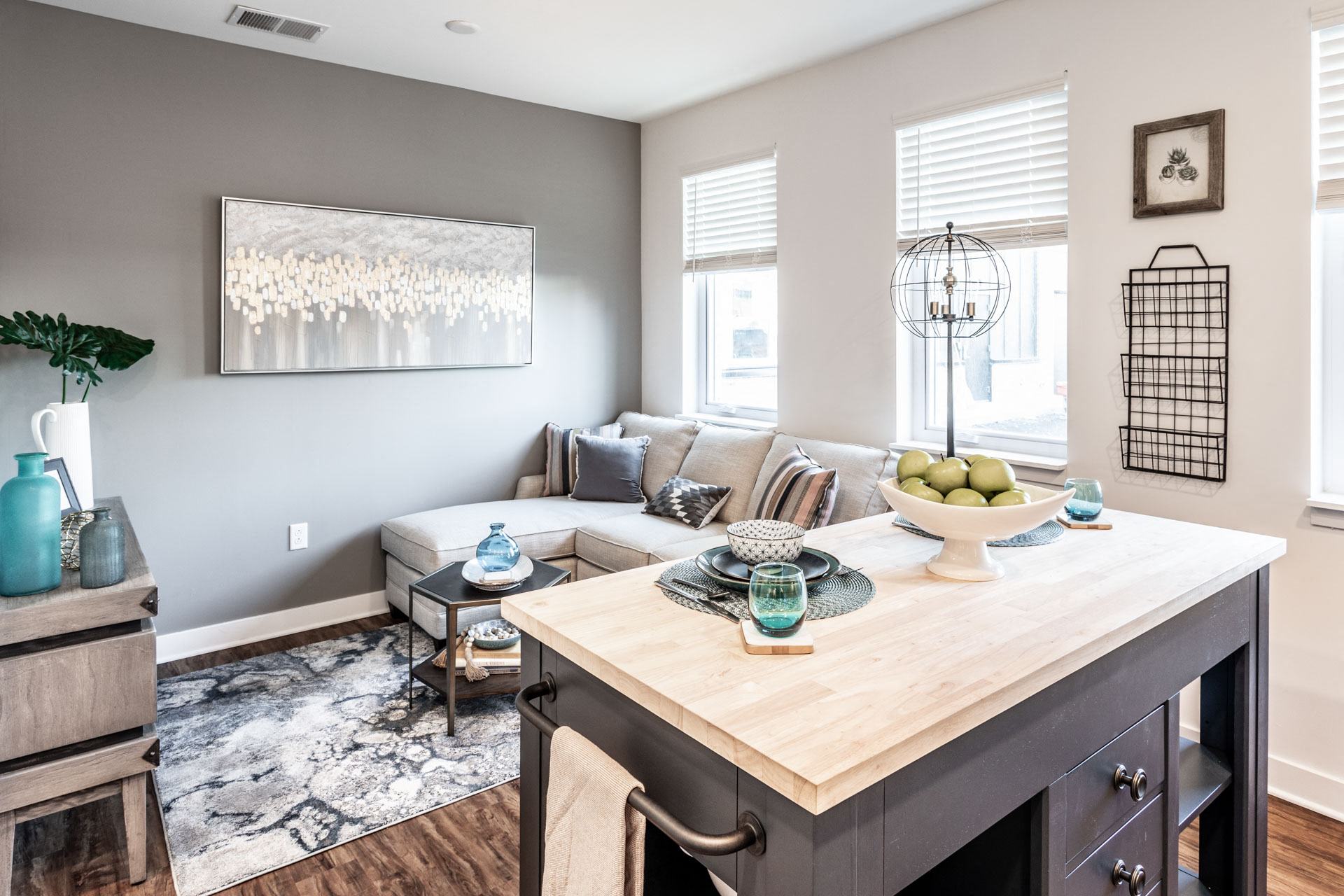 a living room with a kitchen and a couch and a table